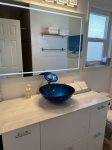 Private bathroom with marble counter lit mirror & new glossy cabinet